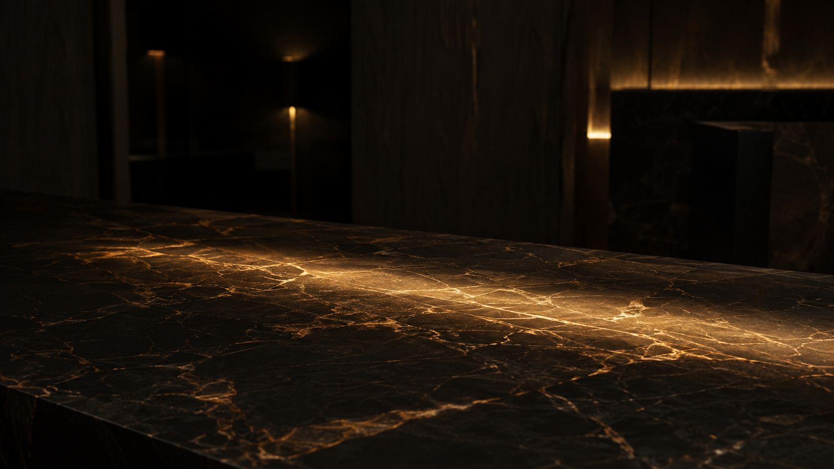 Honed black marble in the Capital Aesthetic lobby, lit by one warm streak of light