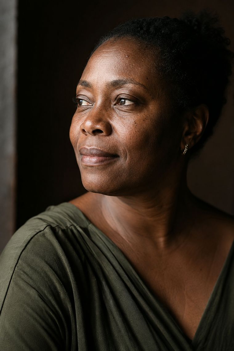 Natural light portrait showing deep skin with visible texture and pigment